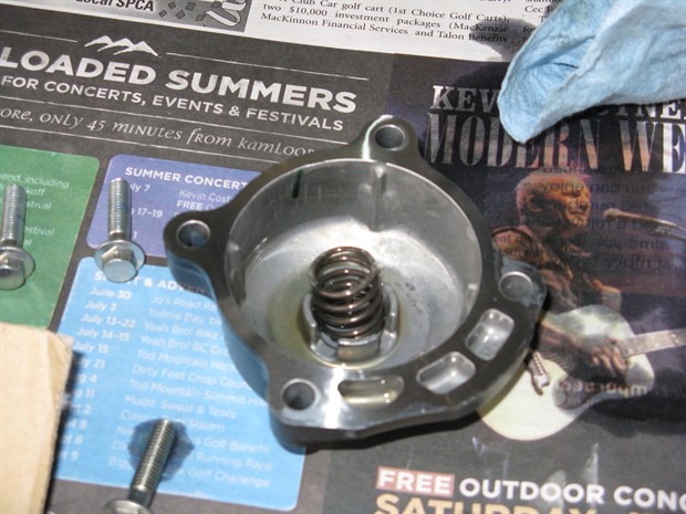 Oil filter cover with spring, 2012 Honda CBR250RA
