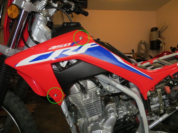 Location of bolts securing the left tank shroud