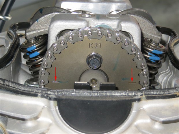 Aligning lines on camshaft sprocket with cylinder head edge